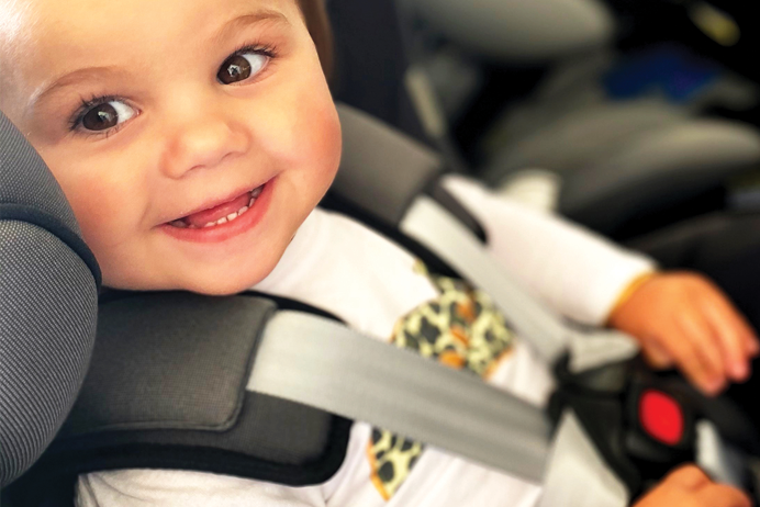 Child smiling in safe car seat